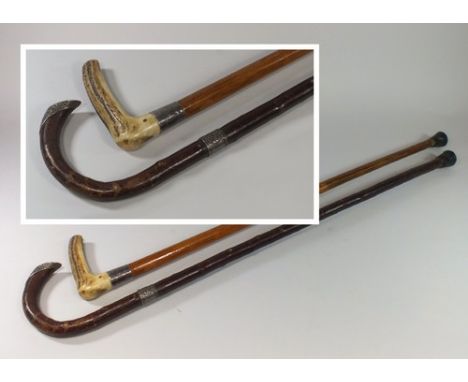 WALKING STICKS.
A silver mounted walking stick with antler handle & one other silver mounted walking stick. 