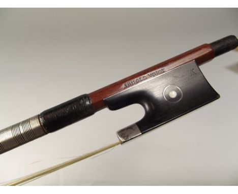 SILVER MOUNTED BOW.
A silver mounted violin bow, the hexagonal stick stamped Arhold Voigt. Full hair. Silver cap missing to a