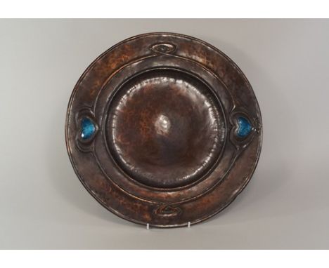 SCOTTISH? COPPER CHARGER.
An Art Nouveau style copper charger with enamel inserts, possibly Scottish. Diameter 38cm. Note: Ve