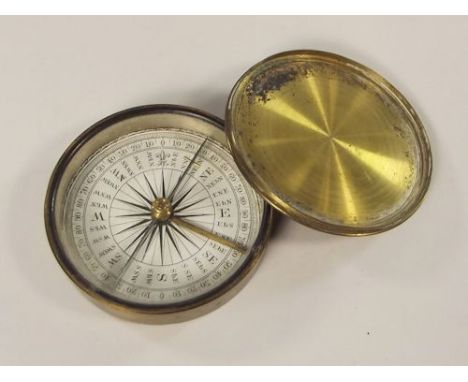 POCKET COMPASS.
A brass cased pocket compass, with paper rose.