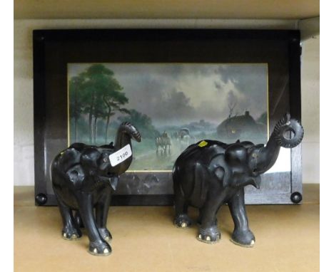 After F Arnold. Village scene with figures, coaches, etc., print, 24cm x 43cm, and two treen carvings of elephants.