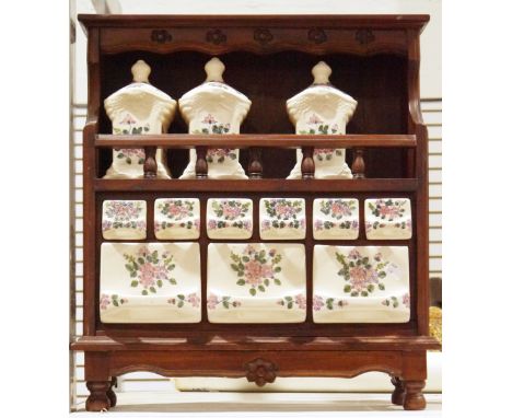 Vintage ceramic spice and herb cabinet&nbsp;with carved wooden frame supported by four bun feet, ceramic drawers with three c