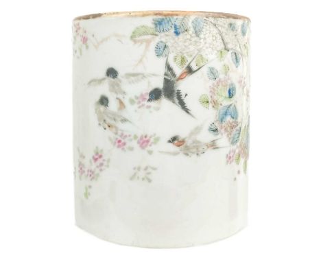 A Chinese famille rose porcelain brush pot, late 19th century. Of cylindrical form and decorated with birds in flight, flower