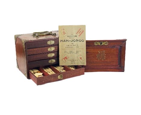 A cased mahogany mahjong set, early 20th century. With bone and bamboo tiles and accessories, 144 tiles and 4 blank tiles, ca