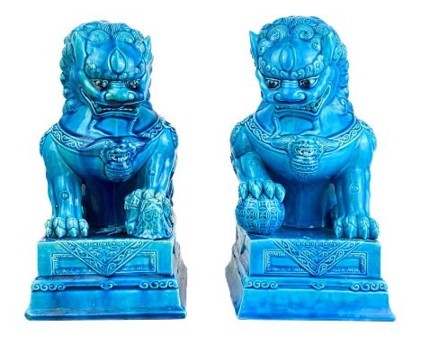 A large pair of Chinese turquoise dogs of fo, circa 1900.  Each with an impressed seal mark, height 29cm, width width 14cm, d
