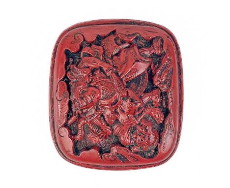 A Japanese cinnabar lacquer netsuke. One side decrorated in relief with a Samurai warrior with dragon, the other bamboo, widt