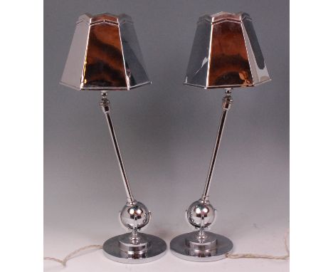 A pair of mid-20th century chromed metal table lamps, the integral hexagonal tapering shades each on ball and socket fittings