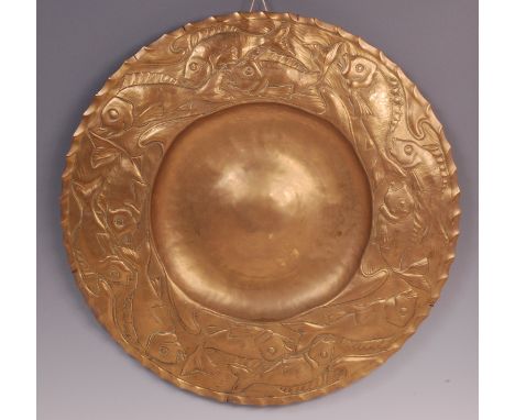 An early 20th century Newlyn School style circular copper charger, of good size, the deep border embossed with stylised trail