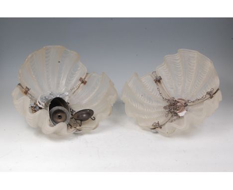 A pair of Art Deco moulded and frosted glass hanging ceiling shades, each of wavy shaped form, with chrome fittings and furth