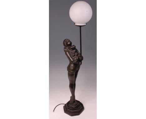 A large Art Deco style green patinated metal table lamp, in the form of Pierrot standing on tiptoes to a stepped octagonal in