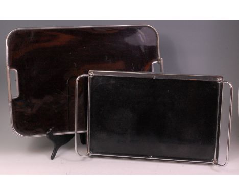 An Art Deco aluminium and black lacquer inset twin handled butlers tray, having rounded corners and raised handles, w.56.5cm;