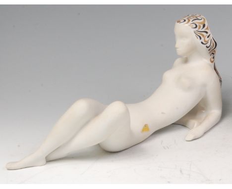 A Royal Dux porcelain figure of a recumbent nude female, wearing a gilt and painted decorated headdress, with raised pink tri