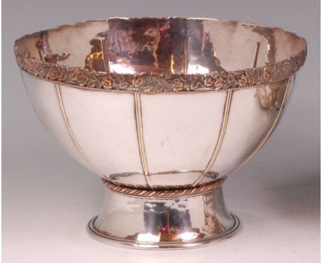 An early 20th century Artificers Guild silver plated footed table bowl, of fluted form with cast foliate band to rim, h.14cm,