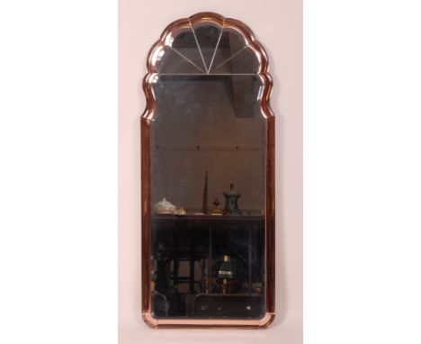 An Art Deco bevelled hanging wall mirror, having a cushion peach surround with sunburst top, dimensions 126 x 54cm Condition 