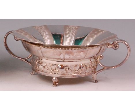 An Art Nouveau WMF silver plated twin handled fruit bowl, having a removable liner, of circular form, with cast floral lower 