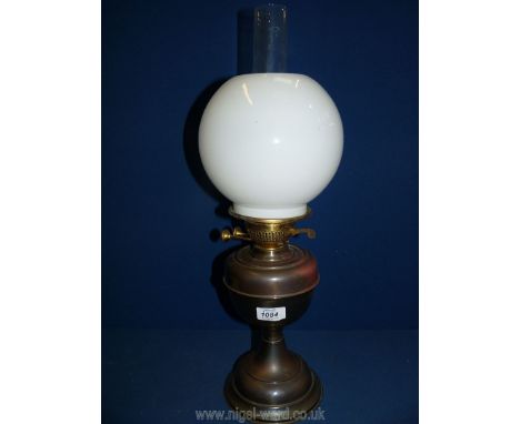 A metal Oil Lamp with white glass shade and chimney, 21 1/2" tall.