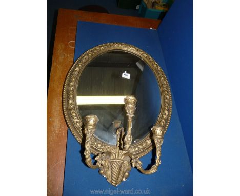 An ornate gilt framed Girandole Mirror with candle holders, 27 1/2'' high x 20'' wide (some damage to lower edging)