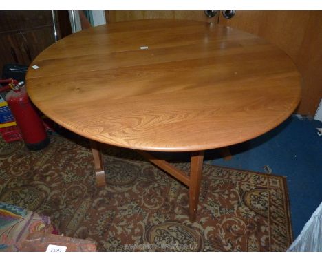 An Ercol drop Elm drop leaf swing leg dining Table, 50 1/2'' wide x 7 5/8'' deep extending to an oval 55'' long x 28 1/4'' hi