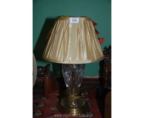 A brass and cut glass lamp with gold fabric shade, 18'' tall.