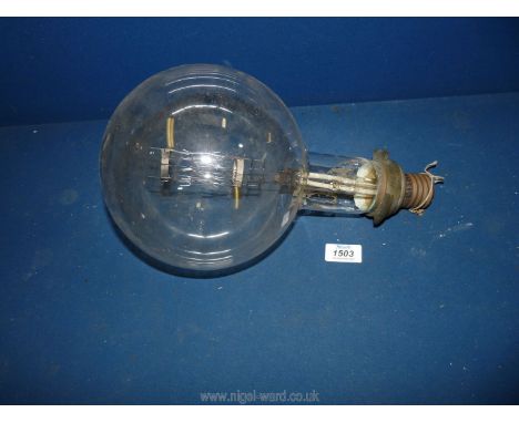 A very large light Bulb having Edison screw fitting and marked G.E.C., Made in England, 100v, 21.4 amp.  On old label and wri