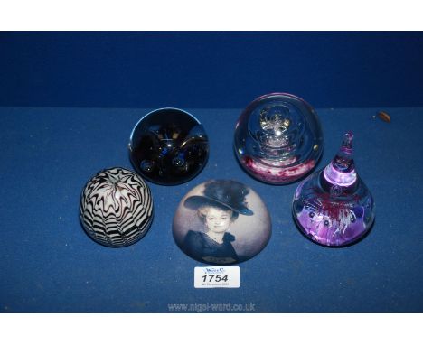 Five purple glass paperweights including teardrop shape, portrait etc.