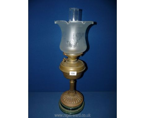 A brass and ceramic oil lamp with etched frosted shade and chimney, 25'' tall.