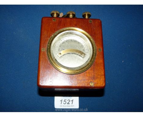 A boxed Mahogany cased Meter reading up to 90 either side of zero and having three brass terminals to the top as well as a ri