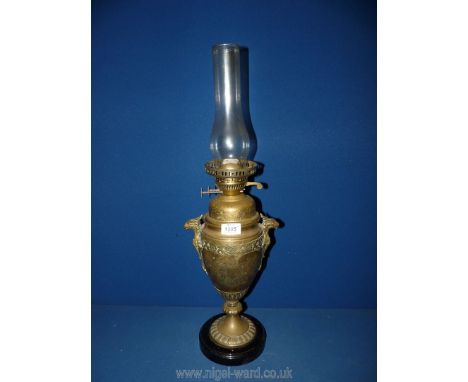 A brass urn shaped oil lamp with bird handles and other etchings, 25'' tall with chimney, no shade.