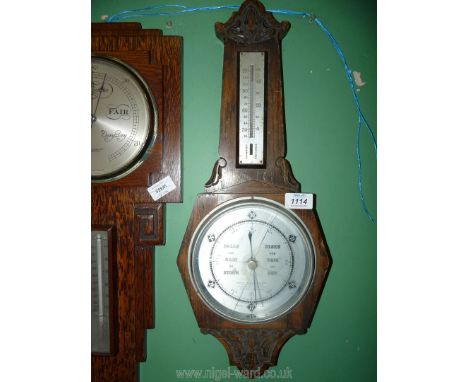 A carved Oak banjo Barometer, 22'' long (face glass cracked). 