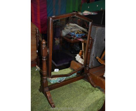 An Oak framed swing Mirror on turned supports, 20 3/4" wide, 27 3/4" high approx.