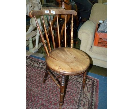 A Welsh Cottage kitchen Chair having a circular seat and turned legs and stick back.