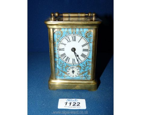 A nice quality Brass cased carriage Clock having a bevelled front window and oval upper window revealing the escapement, the 