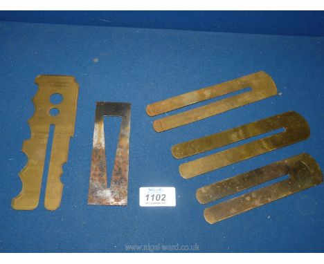 Five various military button cleaning Guards.