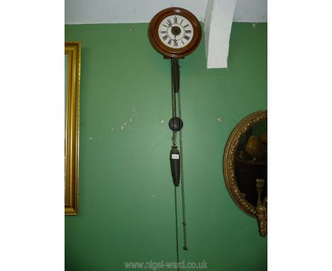 A wall hanging Postman's alarm clock having a pale pink chapter ring to the otherwise white face with Roman numerals. The two