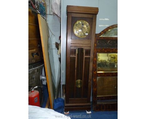An Oak cased Longcase Clock having a brass finished face with Arabic numerals, the two weights and pendulum visible through a
