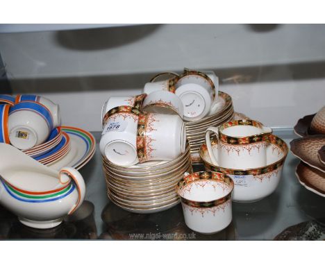 An imari style part Teaset to include nine cups, twelve saucers, eleven tea plates, two sandwich/cake plates, sugar bowl, cre