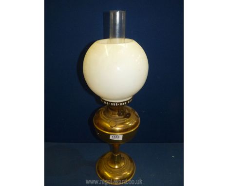 A Brass Oil lamp having a short reeded column, double burner, white globe shade and chimney, 23'' tall overall
