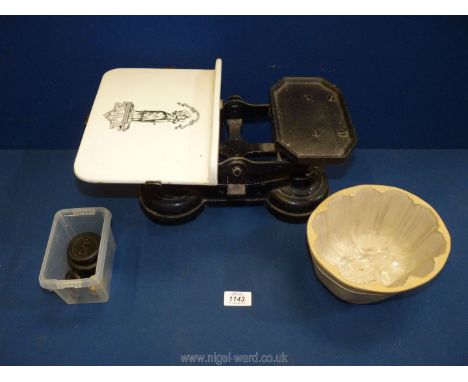 A Victorian kitchen scales and weights with ceramic weighing platform and a ceramic jelly mould. (hairline crack).