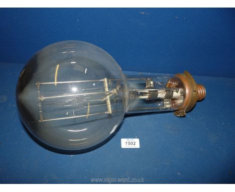 A very large light Bulb having Edison screw fitting and marked Thorn, 3C04, 100 v., 3000w., Ref. No. 82-0726, written on the 