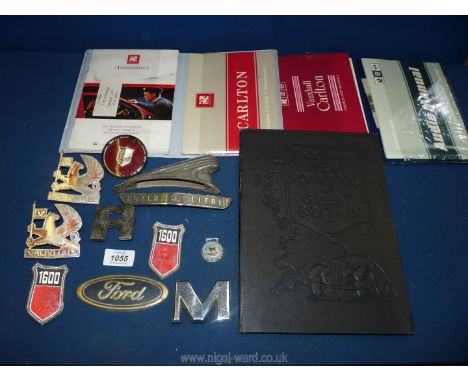 A leather Daily Express Road Book, two car manuals for Vauxhall Carlton and ten car badges including Ford, Vauxhall, Hawk, Ro
