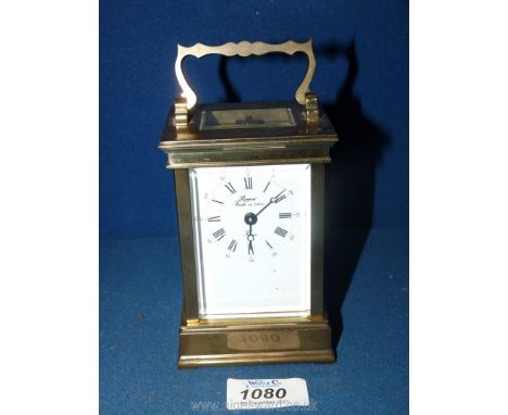 A sharp/angular cornered bevelled windowed Brass cased carriage Clock having Roman hour numerals and Arabic minute numerals, 