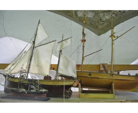 A vintage timber worked study of a two mast sail ship, 54 cm tall x 66 cm long, raised on an associated stand together with a