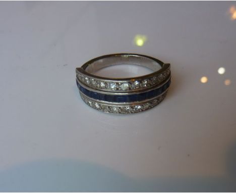 A sapphire and diamond ring, converted from a reversible, centred with a row of channel-set square-cut untested sapphires, fl