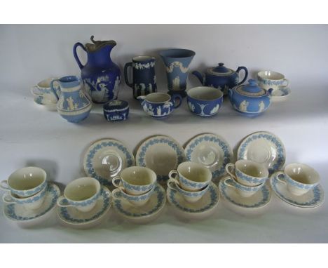 A collection of Wedgwood blue ground Jasperwares including a three piece tea service, three jugs, bowl and cover, trinket box