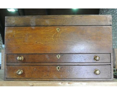 A good quality oak tongue and groove constructed tool chest of rectangular form, the hinged lid set above a pair of graduated