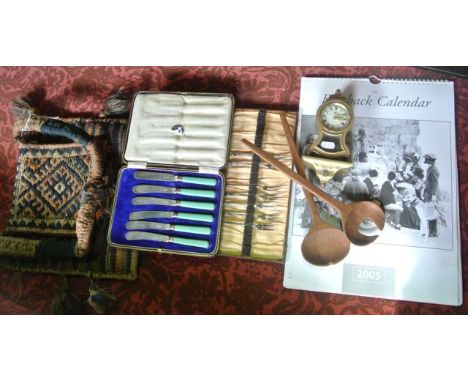 A cased set of plated knives, a part set of plated forks, a boxed Stag miniature bracket clock, an eastern wool saddle bag, a