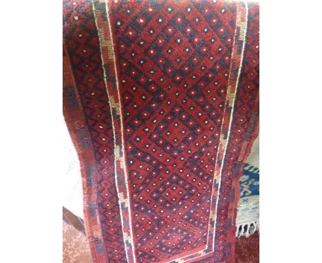 A red ground eastern runner, principally in a red and blue colourway, 235 x 60 cm approx