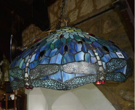 A substantial circular ceiling light shade in the Tiffany style with leaded panels of mottled glass in shades of blue and gre