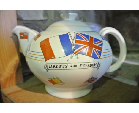 A vintage Crown Ducal teapot with applied decoration depicting a banner reading Liberty and Freedom, with further script read