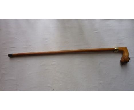 A Malacca walking cane with extensive applied carved timber handle in the form of a dog's mask with inset glass eyes, unusual